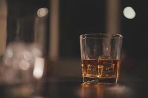 Celebration night, pour whiskey into a glass. Give to friends who come to celebrate photo