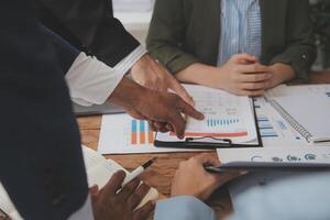 Co working conference, Business team meeting present, investor colleagues discussing new plan financial graph data on office table with laptop and digital tablet, Finance, accounting, investment. photo