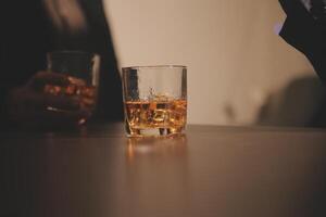 Celebration night, pour whiskey into a glass. Give to friends who come to celebrate photo