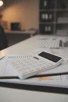 Laptop and paperwork on conference table photo