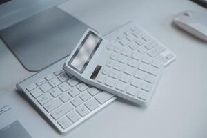 Laptop and paperwork on conference table photo