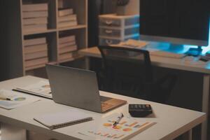 Laptop and paperwork on conference table photo