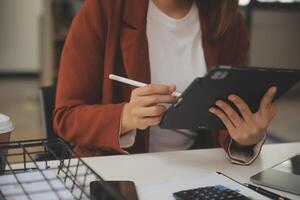 Shot of a asian young business Female working on laptop in her workstation. photo