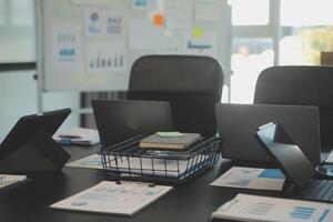 Laptop on a desk in an open financial office. photo