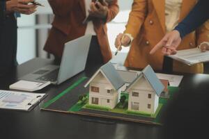 Team of architectures and businessmen discussing and brainstorming on floor plan modification for real estate investment and housing development project photo