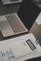 Laptop on a desk in an open financial office. photo