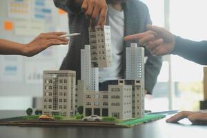 Team of architectures and businessmen discussing and brainstorming on floor plan modification for real estate investment and housing development project photo