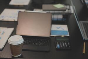 Laptop on a desk in an open financial office. photo