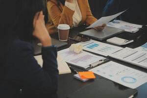 Team of young Asian entrepreneur have serious and disagreement in team meeting for upcoming project for marketing and sale management with skyscraper view for business startup and education concept photo