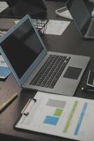 Laptop on a desk in an open financial office. photo