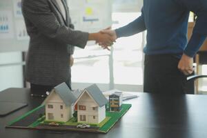 Team of architectures and businessmen discussing and brainstorming on floor plan modification for real estate investment and housing development project photo