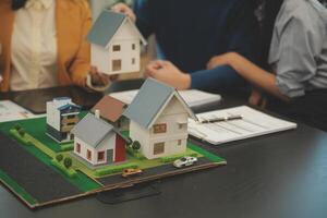 Team of architectures and businessmen discussing and brainstorming on floor plan modification for real estate investment and housing development project photo