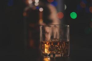 Celebration night, pour whiskey into a glass. Give to friends who come to celebrate photo