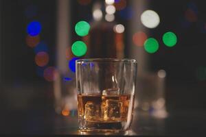 Celebration night, pour whiskey into a glass. Give to friends who come to celebrate photo