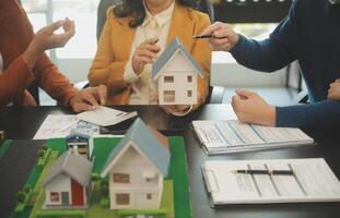 Team of architectures and businessmen discussing and brainstorming on floor plan modification for real estate investment and housing development project photo