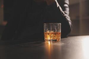 Celebration night, pour whiskey into a glass. Give to friends who come to celebrate photo