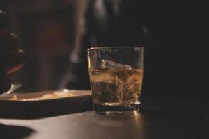 Celebration night, pour whiskey into a glass. Give to friends who come to celebrate photo