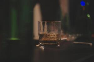 Celebration night, pour whiskey into a glass. Give to friends who come to celebrate photo