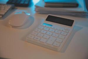 Laptop and paperwork on conference table photo