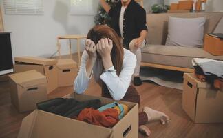 Two Asian blogger showing clothes in front of the camera to recording vlog live streaming at her shop. Online Shopping Cart notion. on sofa at home photo