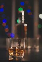 Celebration night, pour whiskey into a glass. Give to friends who come to celebrate photo