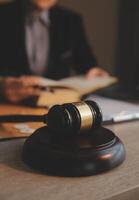 Business and lawyers discussing contract papers with brass scale on desk in office. Law, legal services, advice, justice and law concept picture with film grain effect photo