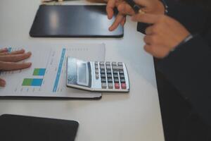 Teamwork with business people analysis cost graph on the desk in the meeting room. The business team discussed meetings and briefing strategies. Negotiation, Analysis, Discussion photo