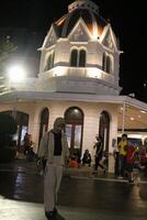 Surabaya - Indonesia, 15 Oct 2023- A girl wearing a hijab visits Surabaya City Square at night. photo