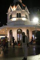 Surabaya - Indonesia, 15 Oct 2023- A girl wearing a hijab visits Surabaya City Square at night. photo