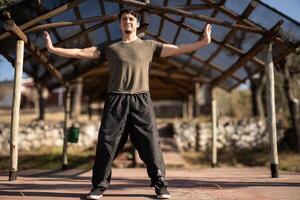 Man Practices Yi Jin Jing in Chi Kung Training. photo