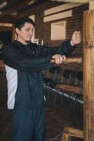 Man training in Kung Fu practice with a Wooden Dummy. photo