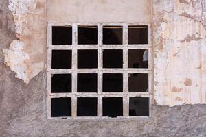 Colseup of a windows of an old abandoned gray paper factory photo