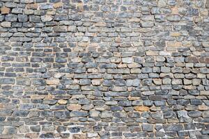 Rough ancient grey brick masonry wall texture background photo