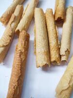 Kue semprong or Asian egg roll. This is a traditional Indonesian wafer or kuih snack isolated on a white background photo