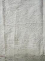 Fabric backdrop White linen canvas crumpled natural cotton fabric Natural handmade linen top view background Organic Eco textiles White Fabric linen texture photo