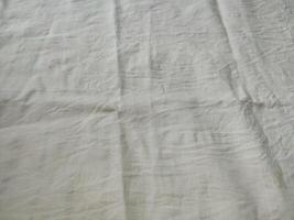 Fabric backdrop White linen canvas crumpled natural cotton fabric Natural handmade linen top view background Organic Eco textiles White Fabric linen texture photo