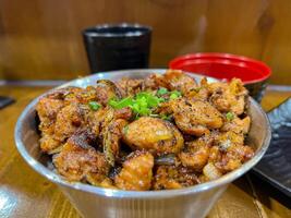 Japanese food called Tori Don or Chicken Rice Bowl or Teriyaki Chicken Don served with miso soup and fried egg roll photo