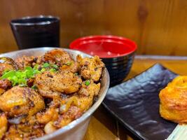 Japanese food called Tori Don or Chicken Rice Bowl or Teriyaki Chicken Don served with miso soup and fried egg roll photo