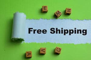 Concept of Free Shipping Text written in torn paper. photo