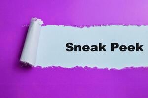 Concept of Sneak Peek Text written in torn paper. photo