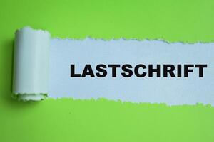 Concept of Learning language - German. Lastschrift it means Direct debit written on torn paper. photo