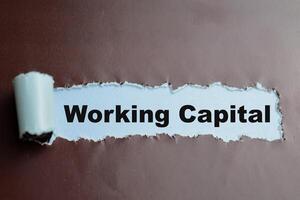 Concept of Working Capital Text written in torn paper. photo