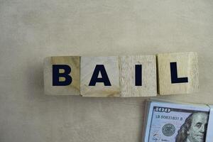 Concept of The wooden Cubes with the word BAIL on wooden background. photo