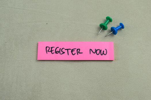 Concept of Register Now write on sticky notes isolated on Wooden Table. photo