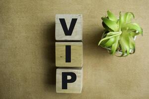 Concept of The wooden Cubes with the word VIP - Very Important Person on wooden background. photo