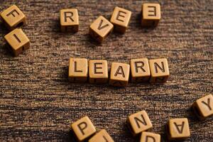 Concept of Learn message written on wooden blocks. Cross processed image on Wooden Background photo