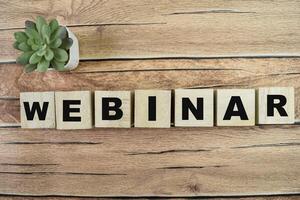 Concept of The wooden Cubes with the word Webinar on wooden background. photo