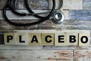 Concept of The wooden Cubes with the word Placebo on wooden background. photo