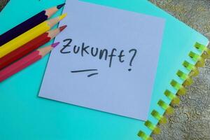 Concept of Learning language - German. Zukunft it means Future written on sticky notes. German language isolated on Wooden Table. photo