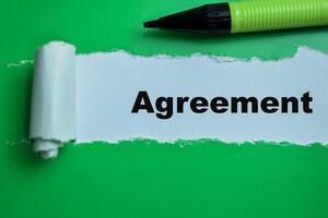 Concept of Agreement Text written in torn paper. photo